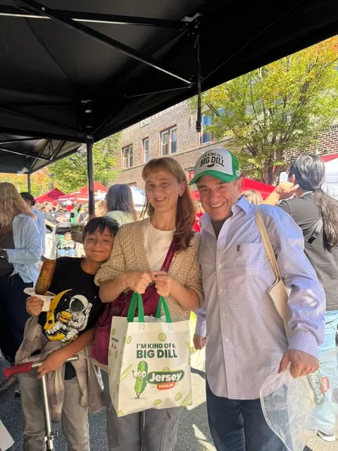 Three customers with a Jersey Pickles tote at our market stand