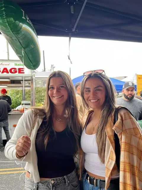 Two customers smiling at the Jersey Pickles stand